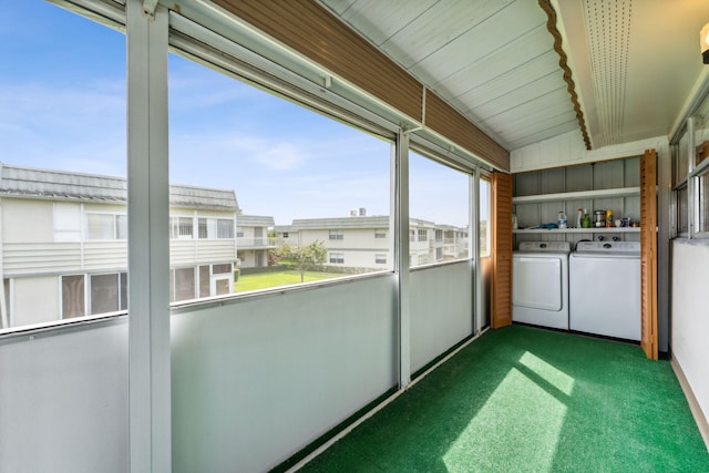 unfurnished sunroom featuring washing machine and dryer