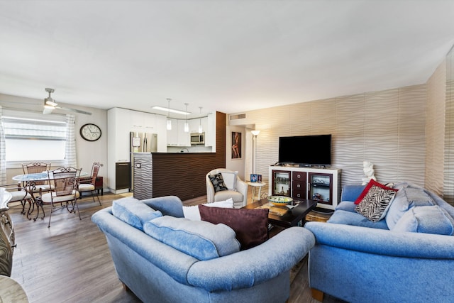 living room with hardwood / wood-style floors and ceiling fan