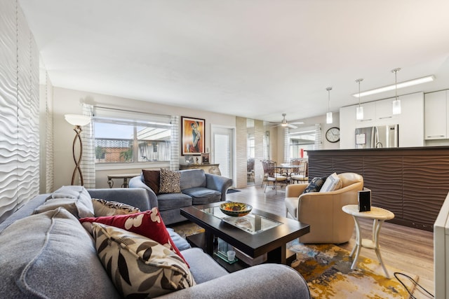 living room featuring hardwood / wood-style flooring and ceiling fan