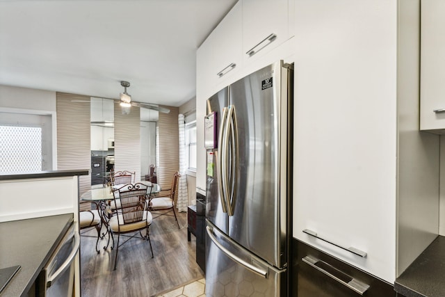 kitchen featuring white cabinetry, ceiling fan, stainless steel appliances, and dark hardwood / wood-style floors