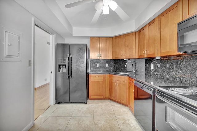 kitchen featuring black appliances, sink, light tile patterned flooring, decorative backsplash, and electric panel