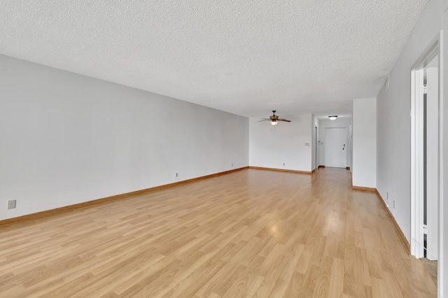 unfurnished living room featuring a textured ceiling, light wood-type flooring, and ceiling fan