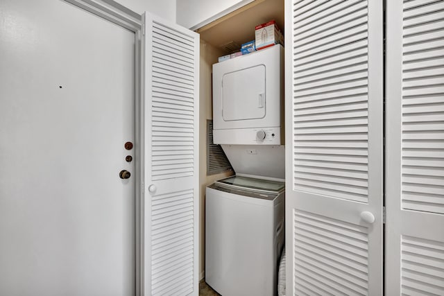 laundry room with stacked washer / dryer