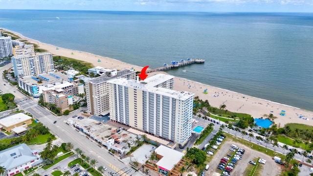 drone / aerial view featuring a water view and a view of the beach