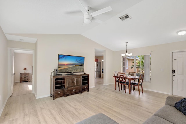 living room featuring vaulted ceiling, light hardwood / wood-style flooring, and ceiling fan with notable chandelier