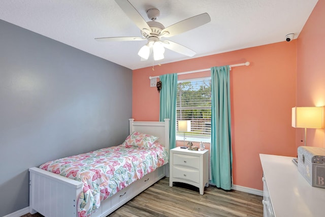 bedroom with hardwood / wood-style flooring and ceiling fan