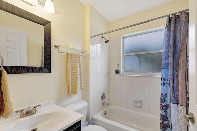 full bathroom with vanity, shower / bath combo with shower curtain, and toilet