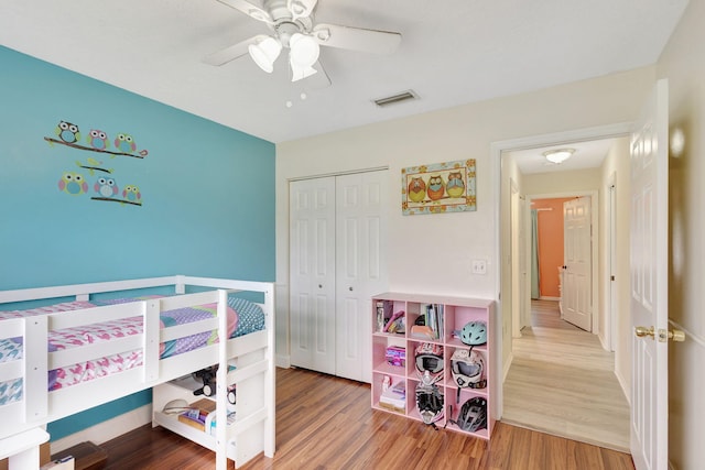 bedroom featuring a closet, hardwood / wood-style floors, and ceiling fan