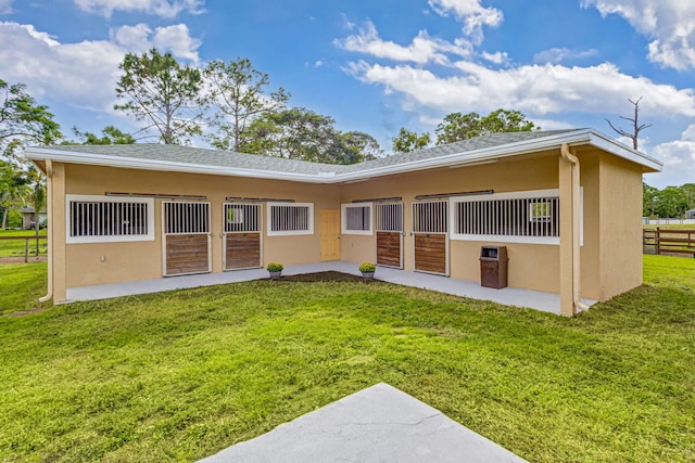 rear view of house featuring a yard