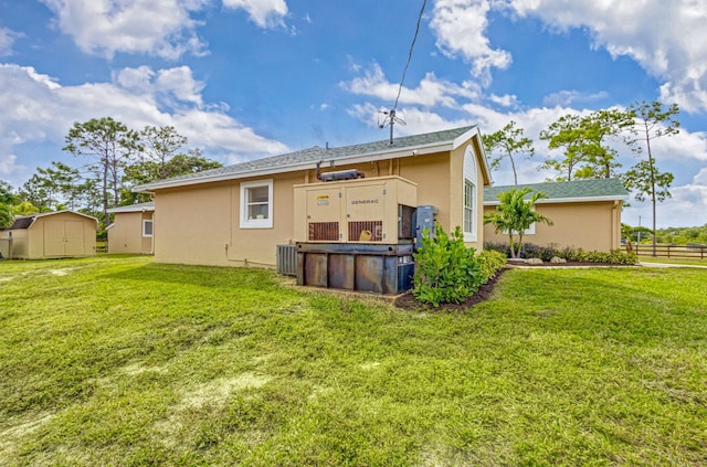 rear view of property featuring a pool, a yard, and a shed