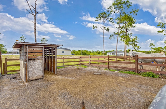 view of yard with a rural view and an outdoor structure