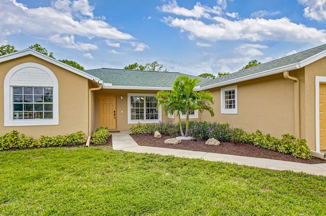 ranch-style home with a front lawn