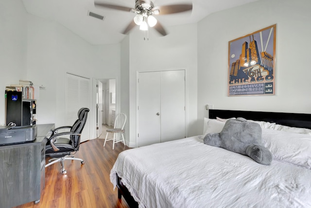 bedroom featuring ceiling fan, high vaulted ceiling, and dark hardwood / wood-style flooring