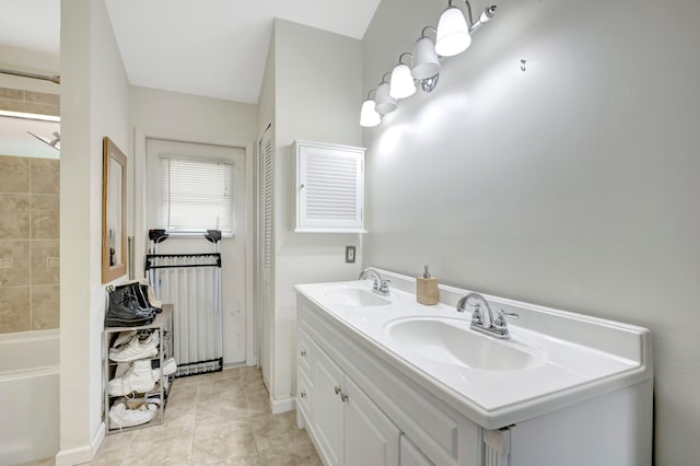 bathroom with vanity, a bath, and tile patterned flooring