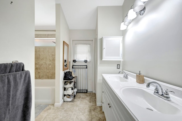 bathroom featuring vanity, tiled shower / bath combo, and tile patterned floors