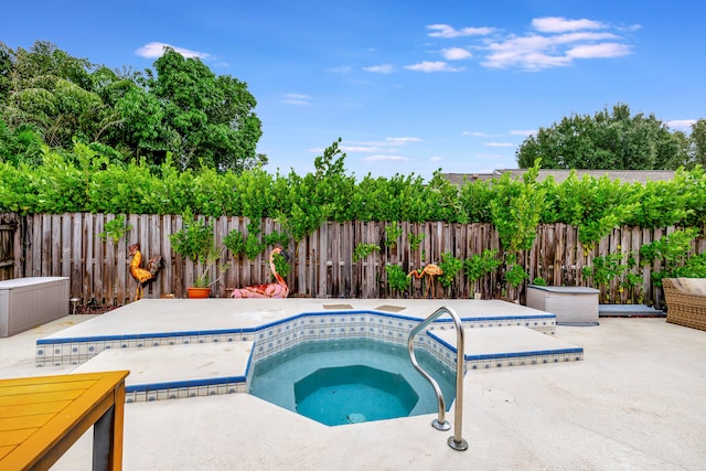 view of pool featuring a patio and an in ground hot tub