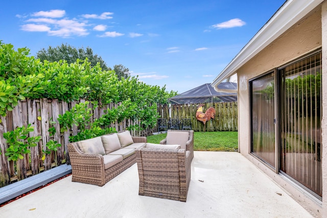 view of patio with an outdoor living space and glass enclosure