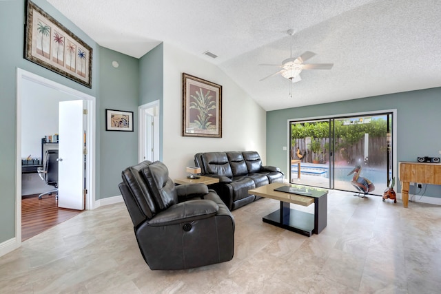 living room with ceiling fan, a textured ceiling, and lofted ceiling