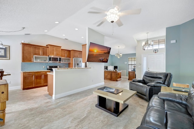 living room with lofted ceiling, a textured ceiling, and ceiling fan with notable chandelier