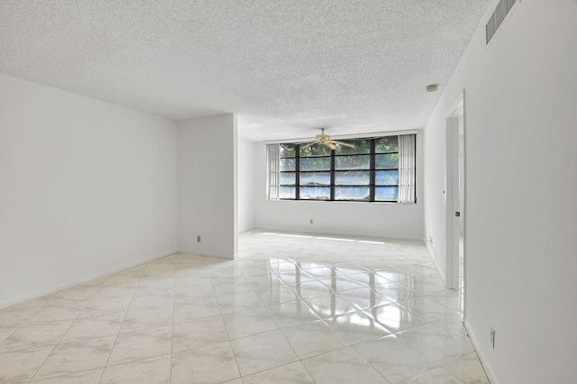 empty room featuring a textured ceiling and ceiling fan