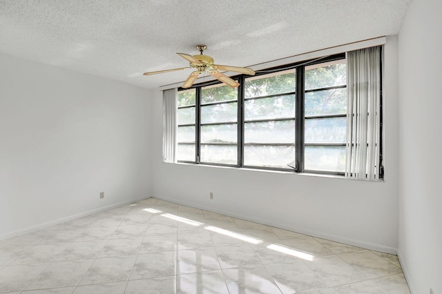 empty room featuring a textured ceiling and ceiling fan