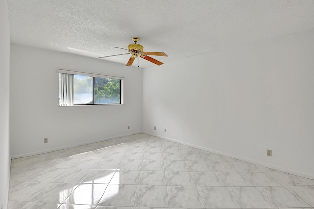 spare room with ceiling fan and a textured ceiling