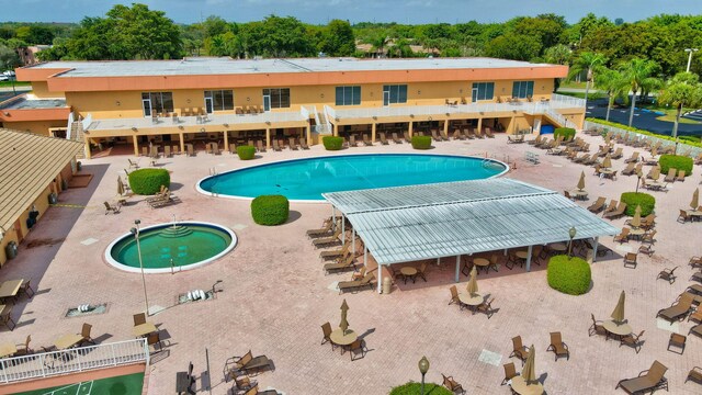 view of swimming pool featuring a patio area and a community hot tub