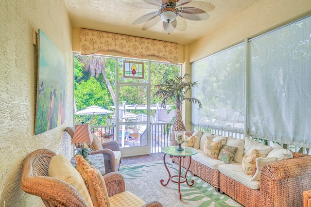 sunroom / solarium with plenty of natural light and ceiling fan