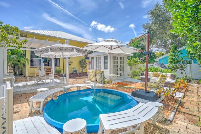 view of swimming pool with a wooden deck, a jacuzzi, and an outdoor structure