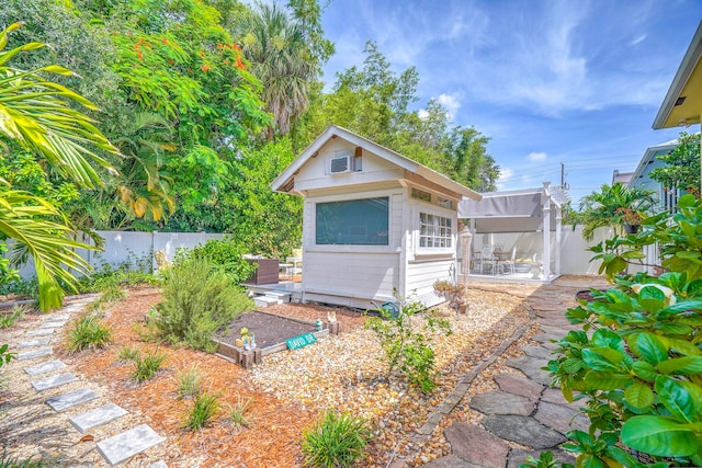 back of house featuring a patio area and an outdoor structure