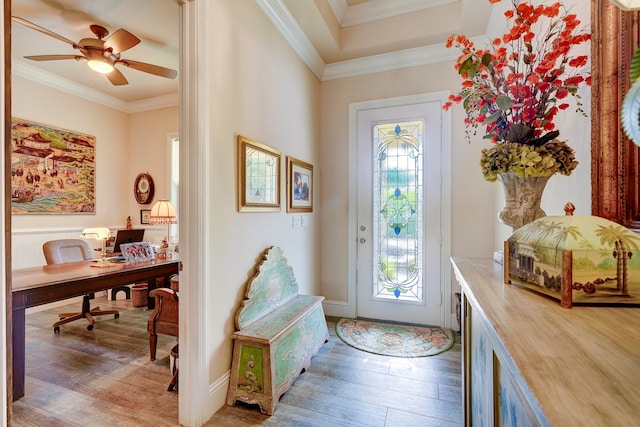 foyer entrance with crown molding, hardwood / wood-style flooring, and ceiling fan