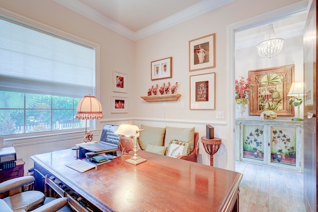 office area with ornamental molding, light hardwood / wood-style flooring, and an inviting chandelier