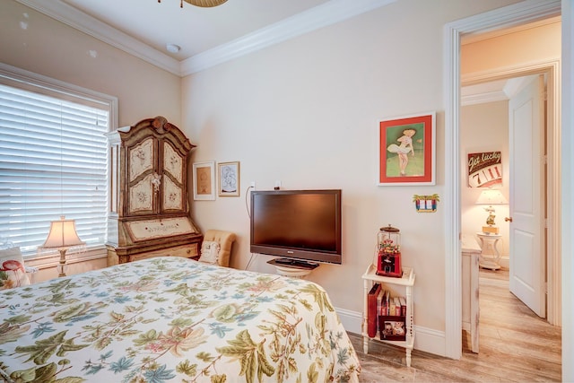 bedroom featuring crown molding and light hardwood / wood-style floors