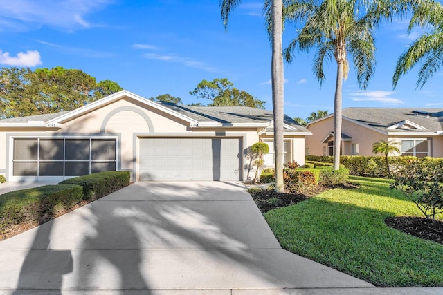 ranch-style house with a garage and a front yard