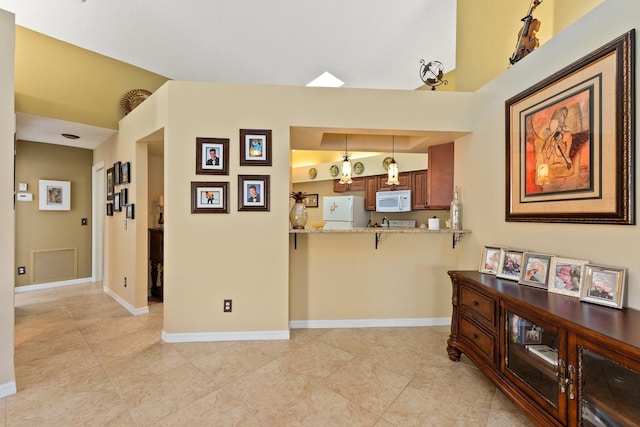 hallway with lofted ceiling