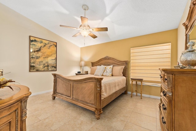 tiled bedroom with ceiling fan and a textured ceiling