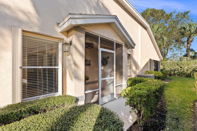 property entrance featuring central AC unit