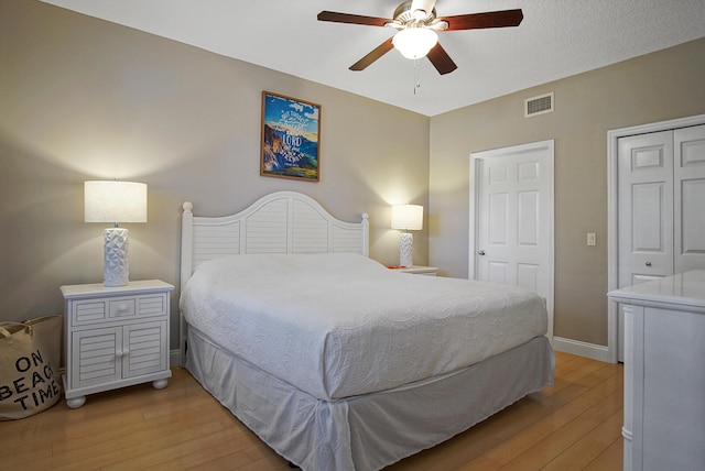 bedroom with light hardwood / wood-style flooring and ceiling fan