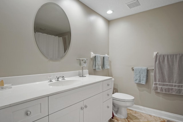 bathroom featuring vanity and toilet