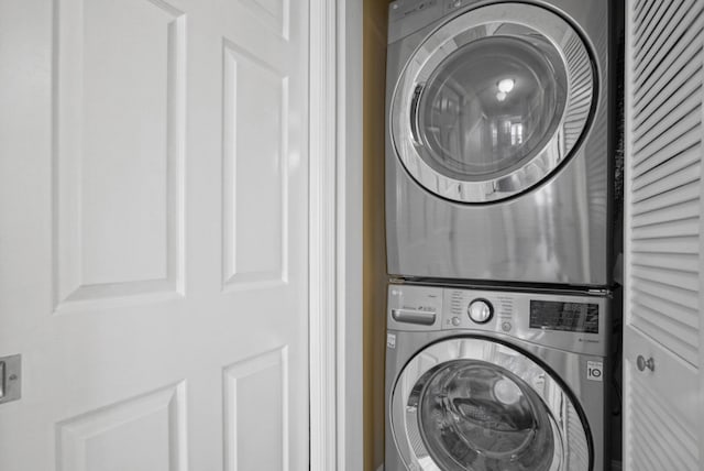 laundry room with stacked washer / drying machine