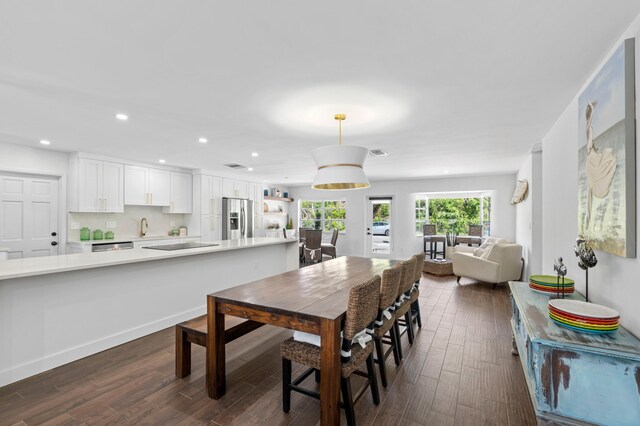 dining space featuring dark hardwood / wood-style floors and sink