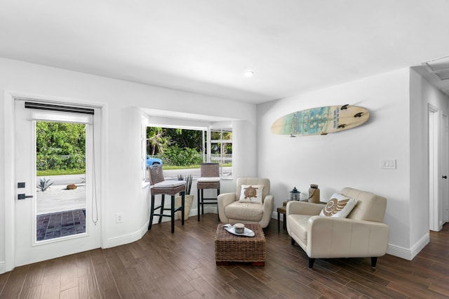 sitting room featuring dark hardwood / wood-style floors and a healthy amount of sunlight