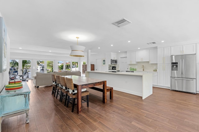 dining area with dark hardwood / wood-style flooring