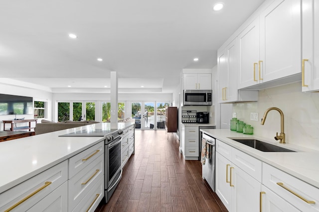 kitchen with white cabinetry, sink, appliances with stainless steel finishes, french doors, and dark hardwood / wood-style flooring