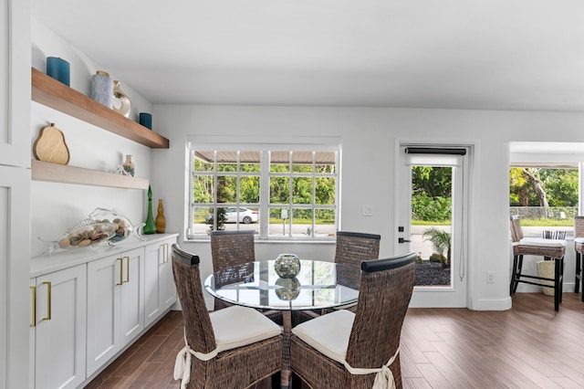 kitchen with light stone counters, white cabinetry, appliances with stainless steel finishes, sink, and dark wood-type flooring