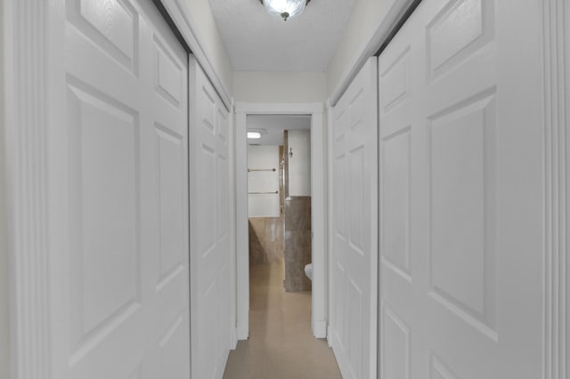 hallway featuring a textured ceiling