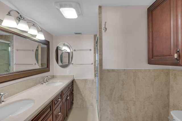 bathroom with vanity and tile walls