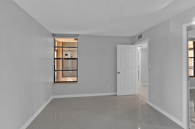 empty room with concrete flooring