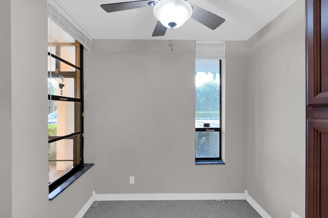 unfurnished room with a wealth of natural light and ceiling fan