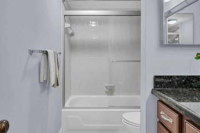 full bathroom featuring vanity, tiled shower / bath, and toilet